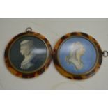 A pair of circular framed portrait miniatures indi
