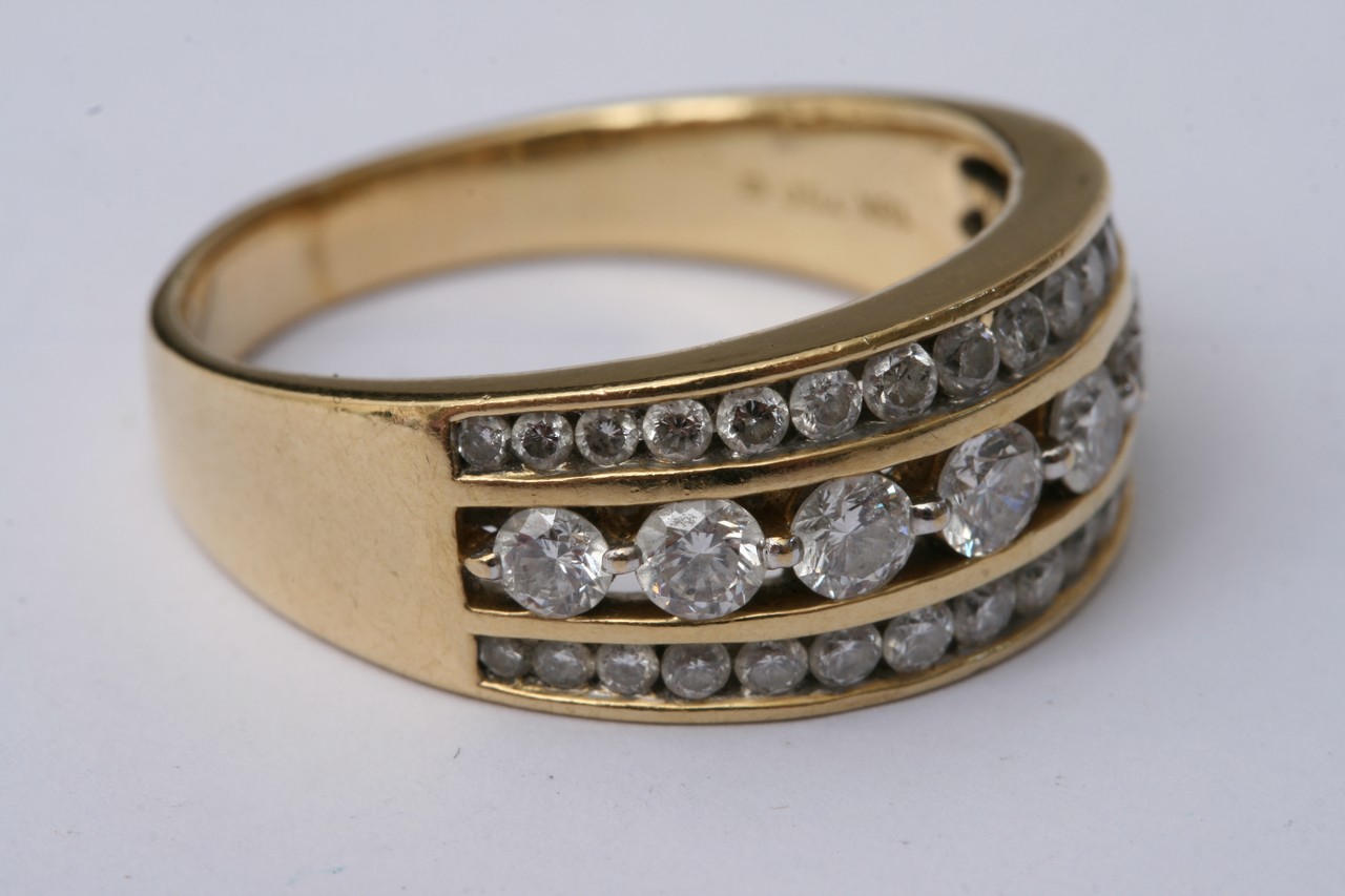 An 18c gold ring set with three rows of diamonds. - Image 3 of 4