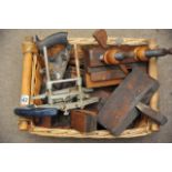 A basket of various tools including wood planes.