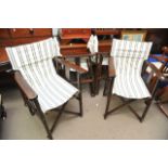 A set of four folding campaign type garden chairs.
