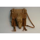 A full alligator skin handbag includes head, teeth