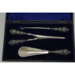 A cased silver shoehorn, boot hook and glovestretc