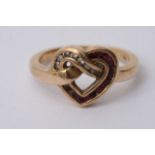An unusual gold entwined heart ring set with ruby
