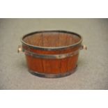 An old wooden ice bucket with white metal mounts