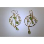 A pair of peridot and pearl hoop earrings.