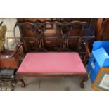 A Chippendale style two seat sofa.