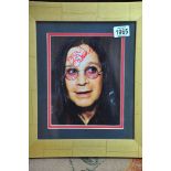 A mounted and framed signed Ozzie Osbourne photo