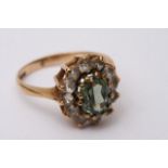 A boxed 9ct gold ring set with a central green sto