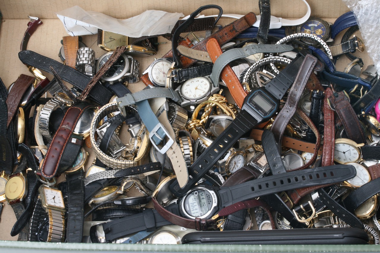 A box containing various Quartz watches for spares