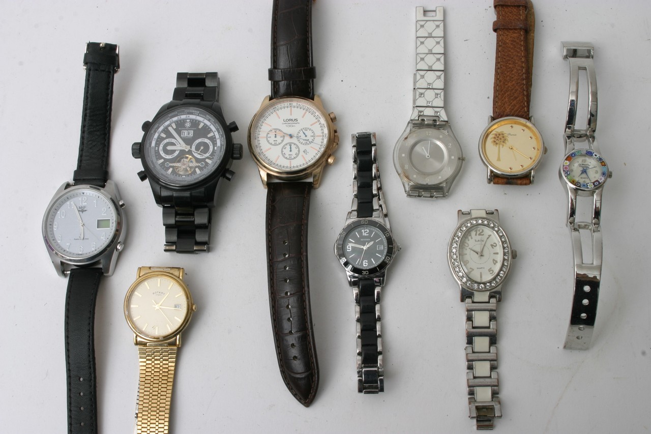 A bag containing various designer quartz watches,