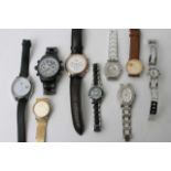 A bag containing various designer quartz watches,