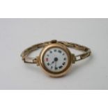 A 9ct gold vintage lady's watch with an enamel dia