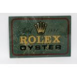 A glass shop display sign advertising Rolex Oyster