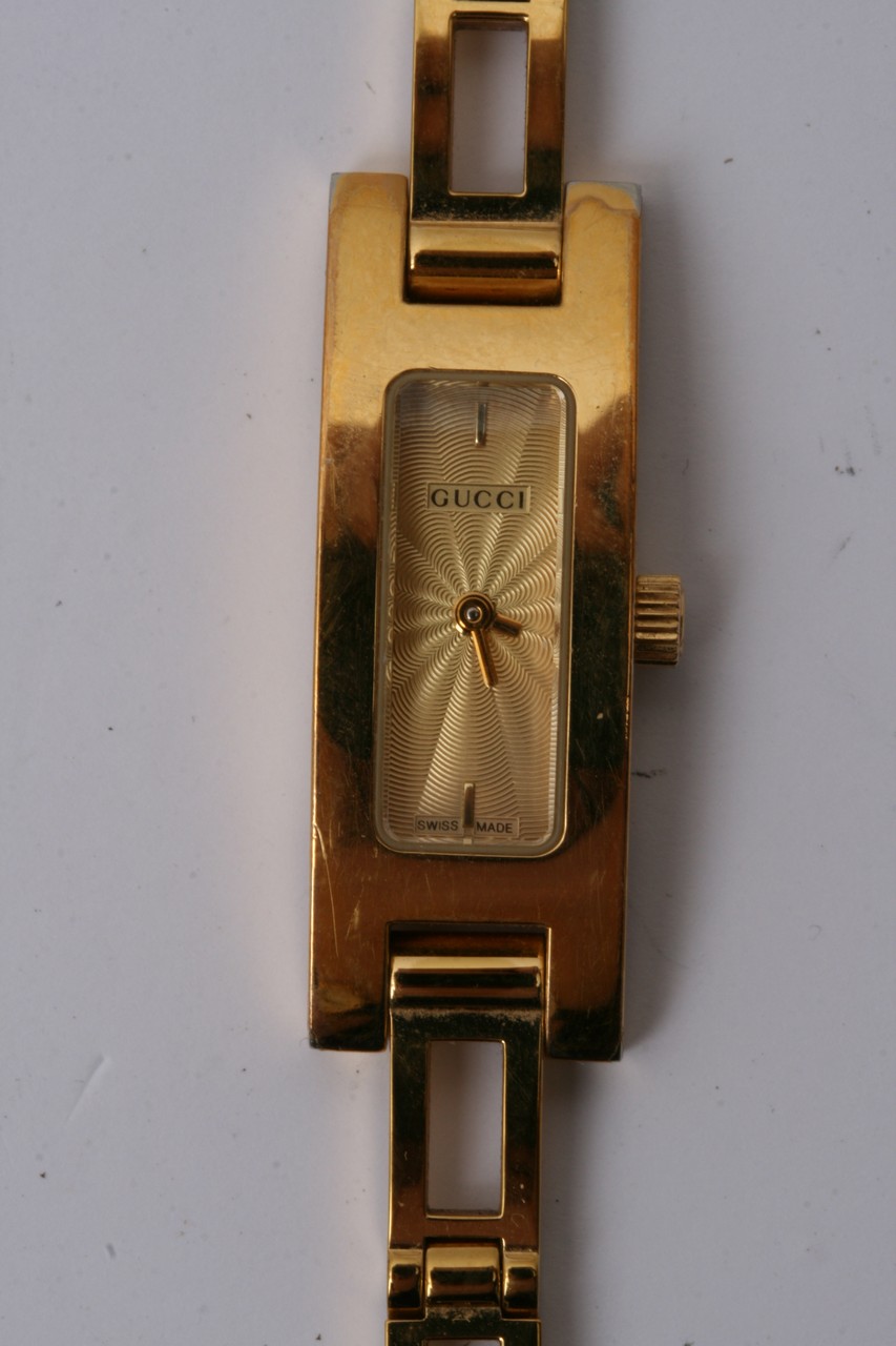 A Gucci watch with a plated strap