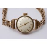 A ladies 9ct gold Tissot watch and strap.