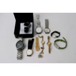 A bag containing various designer watches includin