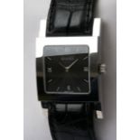 A gents Gucci watch with a leather strap.