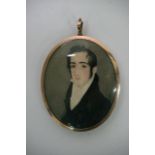 An oval miniature portrait of a gentleman with mem