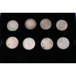 A collection of eight predominantly silver coins c
