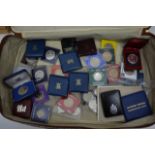 A suitcase contains various cased and proof coin s
