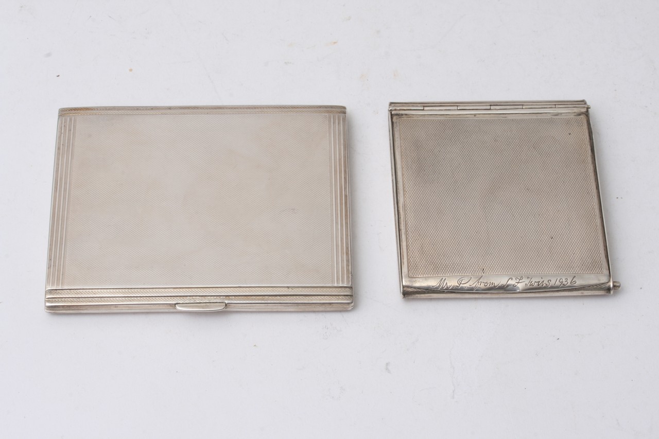 Two silver cigarette cases.