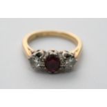 An 18ct gold ring set with two diamonds and a ruby