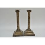 A pair of silver Corinthian column candlesticks, L