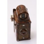 A vintage Coronet midget camera.