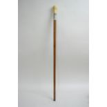 An ivory handled walking stick with a naturally de