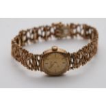 A 9ct gold ladies petite wristwatch with unconvent