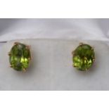 A pair of antique 9ct gold earrings set with perid