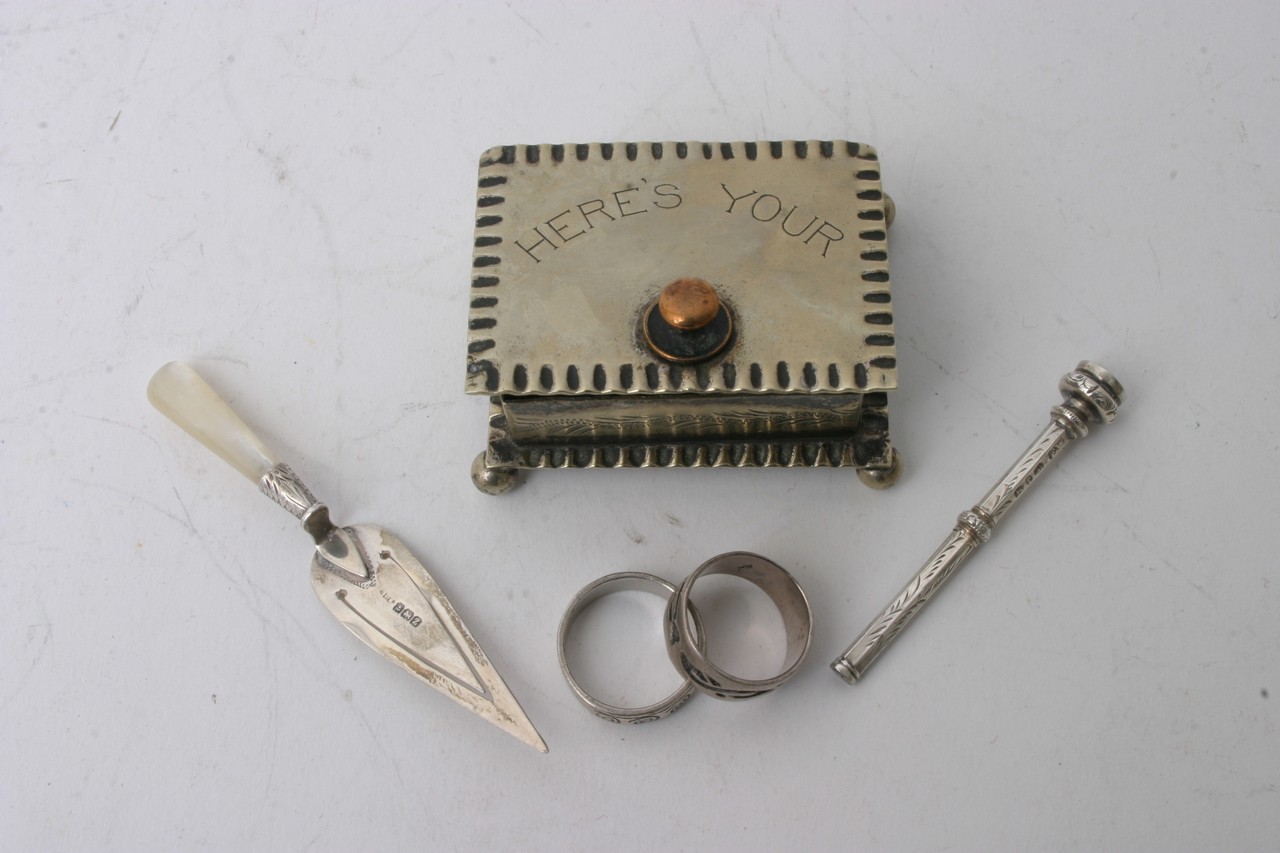 A silver page marker, two rings, silver plated box