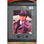 A mounted and framed signed Michael Caine photo