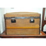 A wooden bound doomed top travelling trunk