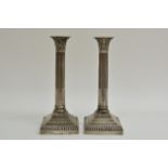 A pair of silver Corinthium column candlesticks wi