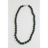 A jade bead necklace, each bead having a diameter