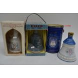 Three boxed and unopened Bell's whisky decanters.