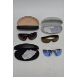 Three pairs of cased designer sunglasses including