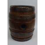 A walking stick stand in the form of a barrel.