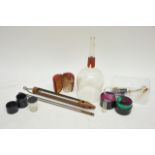 Three leather cased apothecary measuring cups and