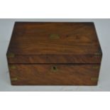 A walnut writing box with brass inlays.