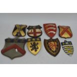 A collection of assorted wooden Coats of Arms pain