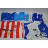 A collection of signed football shirts, including