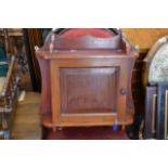 A small mahogany hanging cabinet with single door