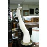 An unusual electric table lamp in the form of a ladies leg on a base, includes shade.