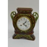 A green glazed pottery mantle clock