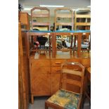 An Art Deco burr walnut dining room suite, comprising four chairs break front sideboard and dining