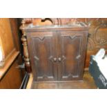 An oak cabinet with a pair of doors