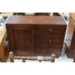 A small pine stained cabinet with a single cupboard and three drawers