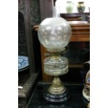 A Victorian glass oil lamp with etched shade